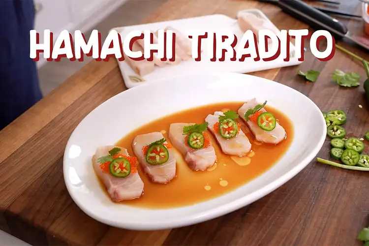 Sliced hamachi on a plate with ponzu sauce and sliced chilis