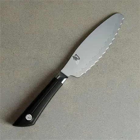 Sora Ultimate Utility Knife on a light stone surface.