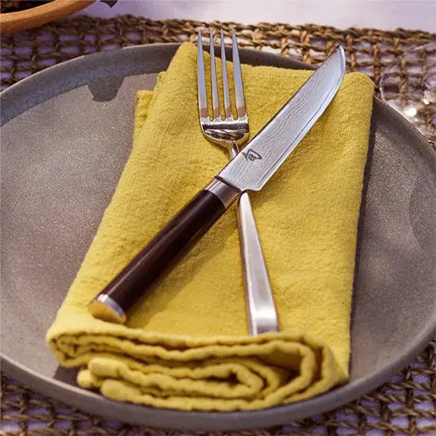A Classic Steak knife is shown as part of a table setting.