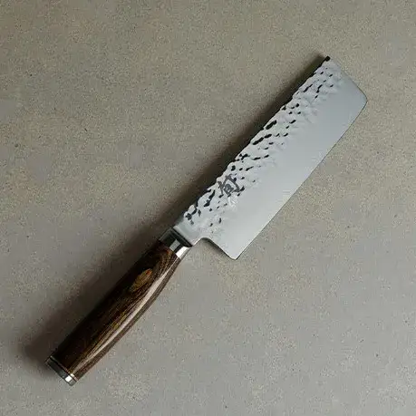 Premier Nakiri knife on a light stone surface.