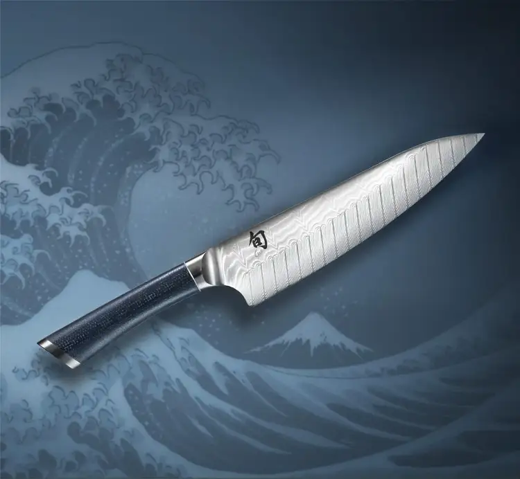 Shun Shiranami knife over stylized Japanese wave artwork.
